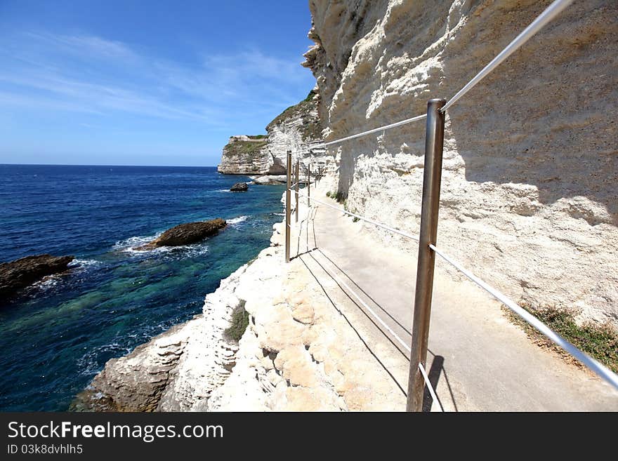 Limestone rock cliffs with a walkway