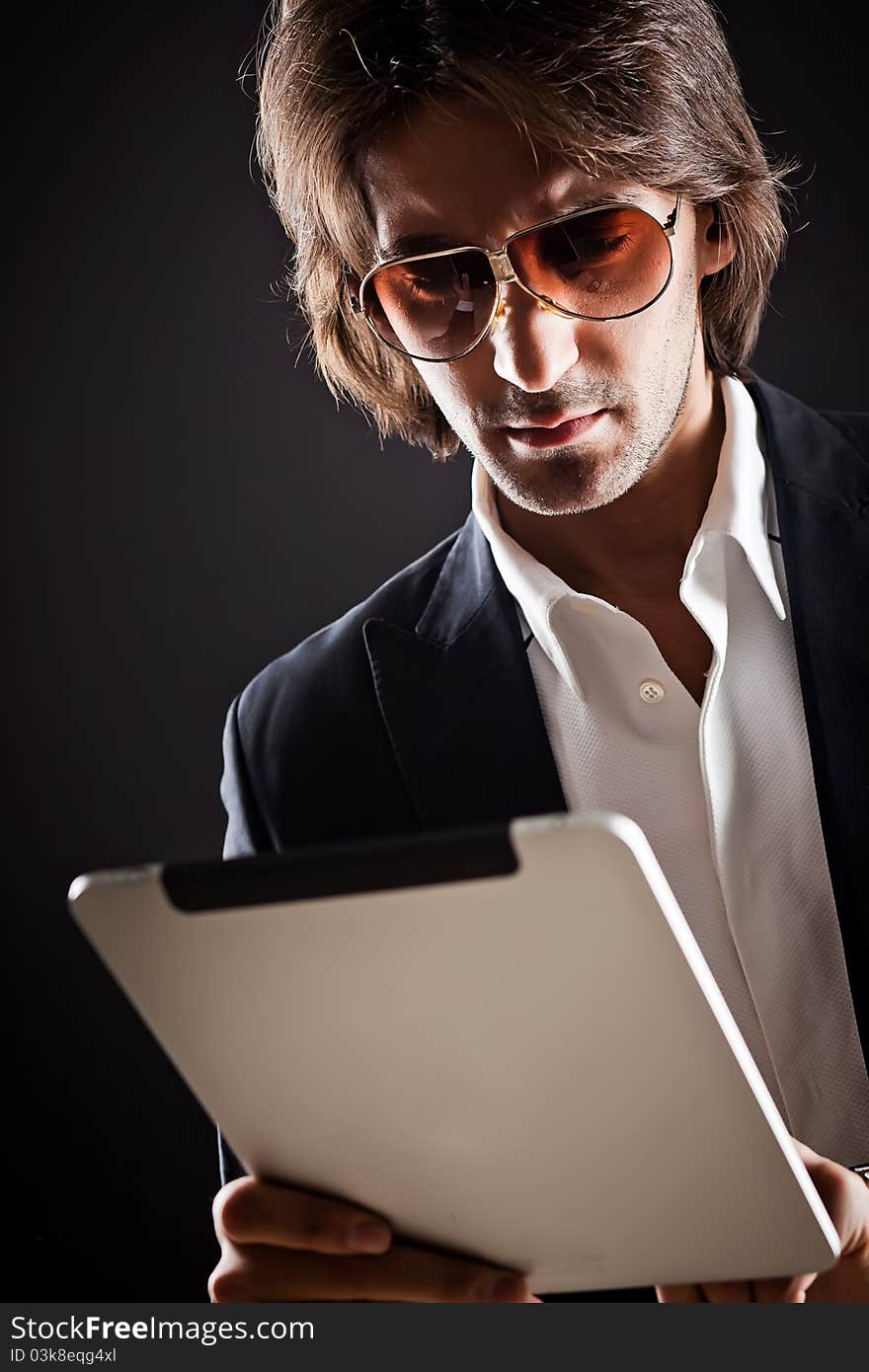 Young serious man in sunglasses and suit. Young serious man in sunglasses and suit