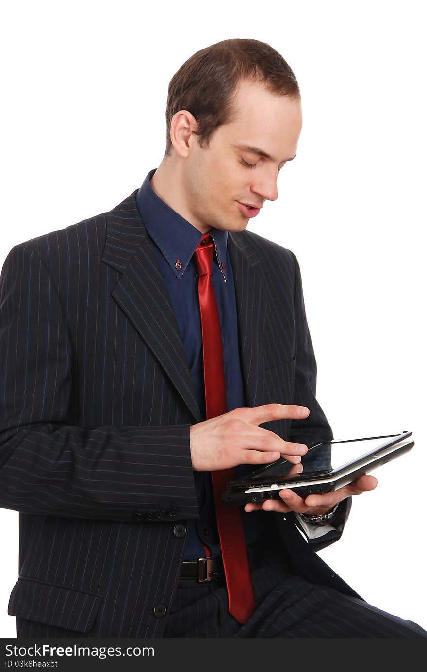 The young enterprising man with the laptop isolated on a white b