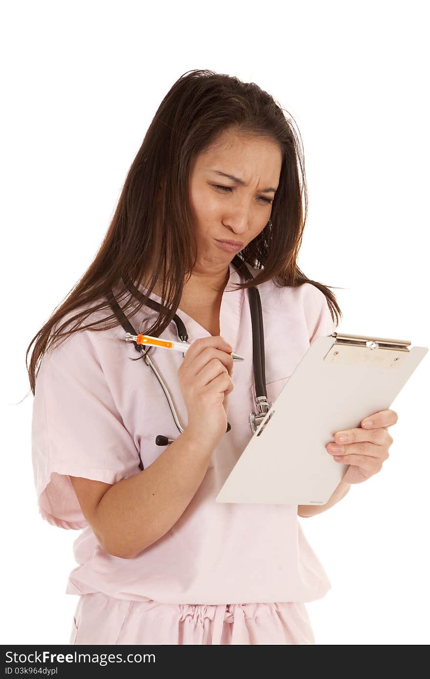 A woman in her scrubs with a frustrated expression on her face. A woman in her scrubs with a frustrated expression on her face.