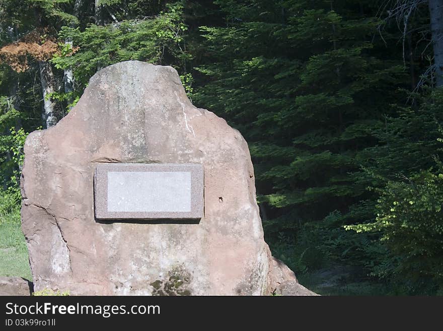 Massive stone with a blank sign on it