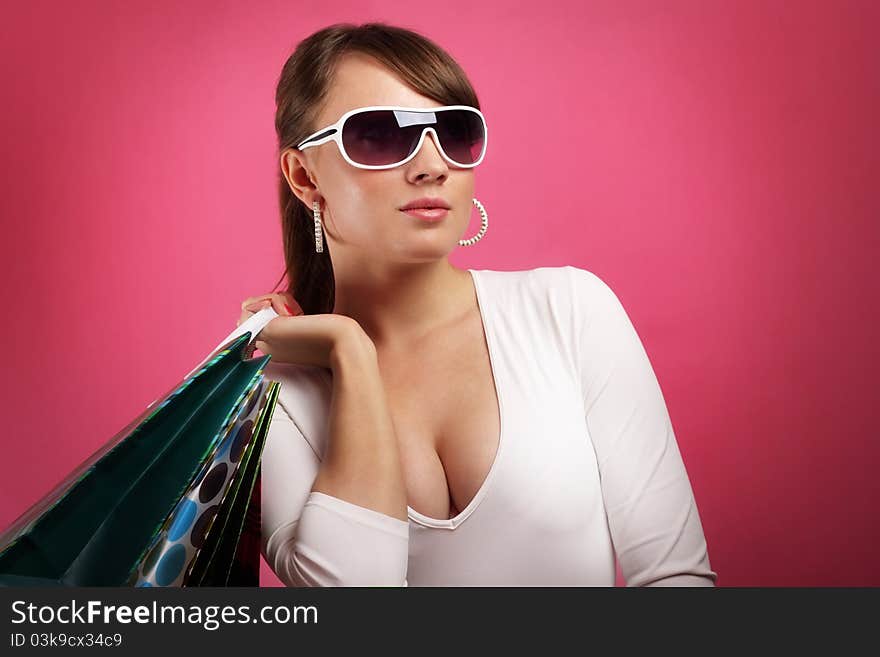 Stylish Girl with shopping bags on red background