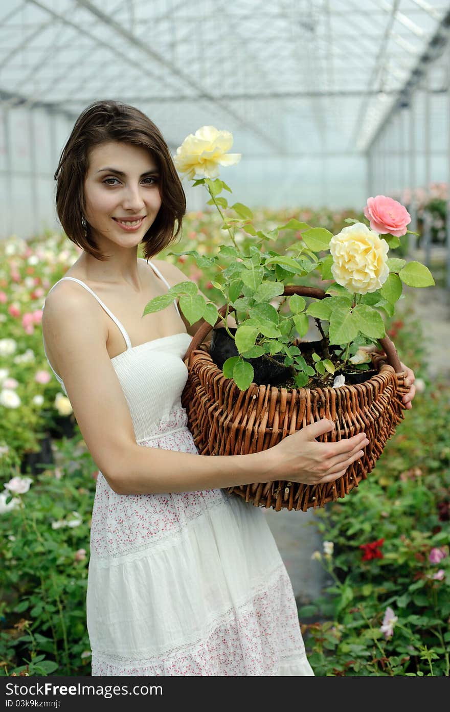 An image of a nice young girl in a greenhouse. An image of a nice young girl in a greenhouse