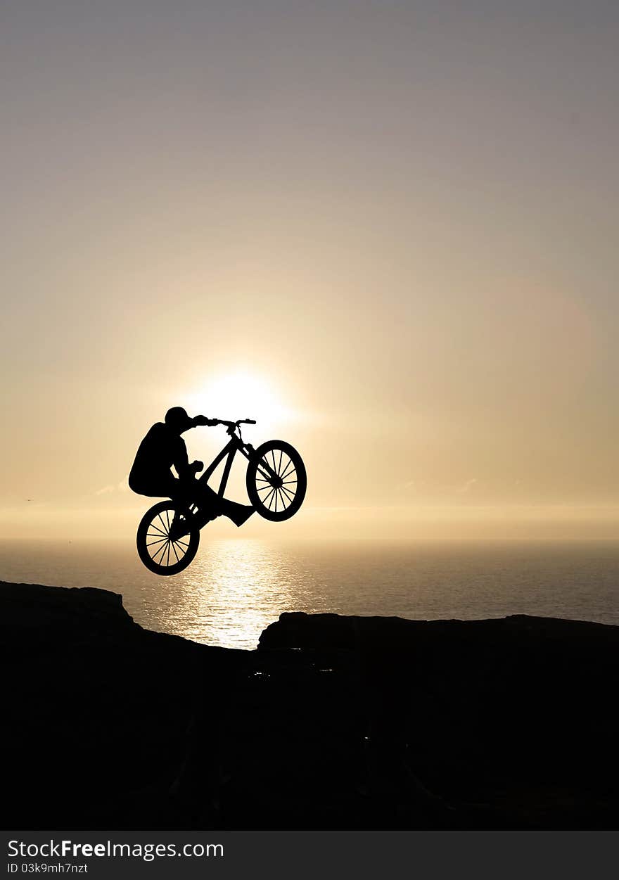 Sunset biker jumping at sunset