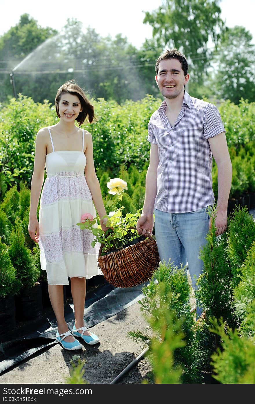 An image of a young couple with basket with roses. An image of a young couple with basket with roses