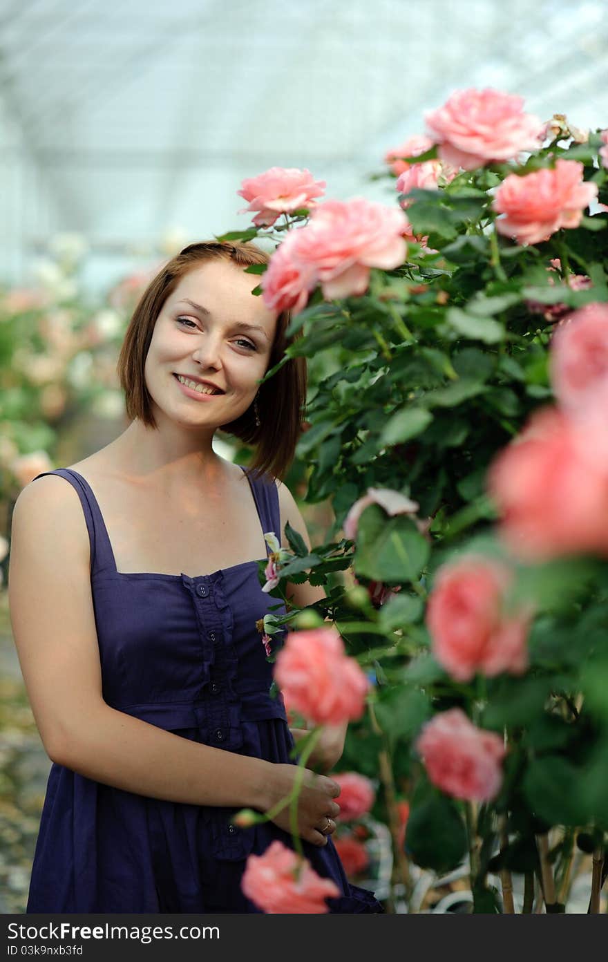 An image of a young woman in the greenhouse. An image of a young woman in the greenhouse