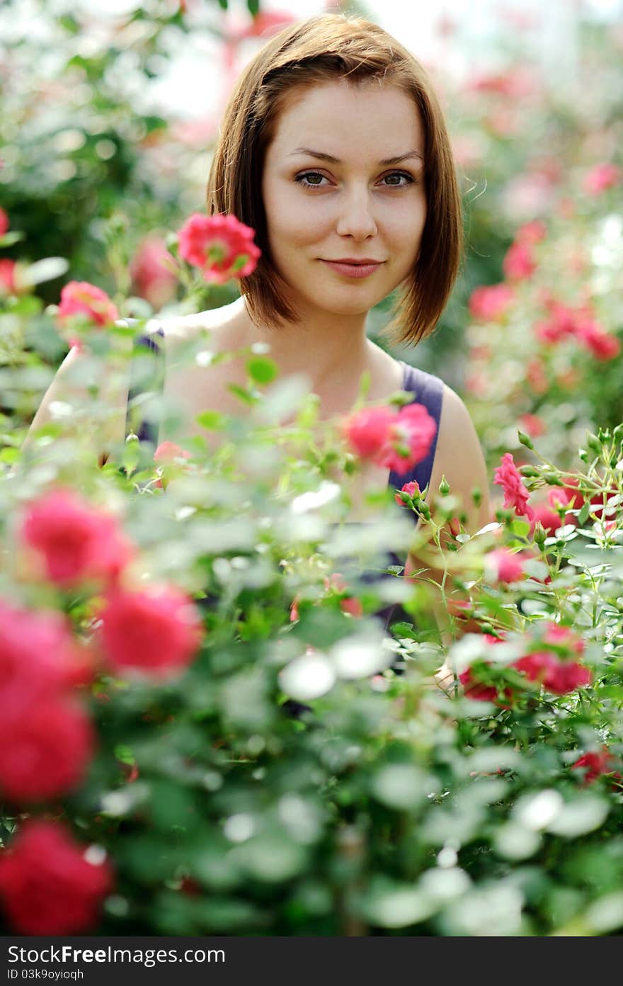 An image of a young beautiful woman and roses