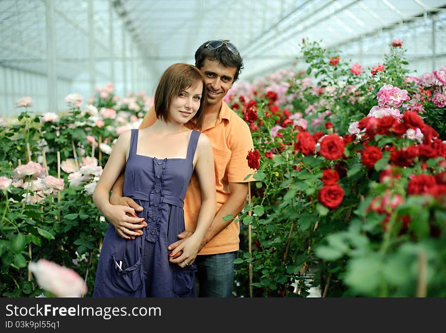 An image of a woman and a man in greenhouse. An image of a woman and a man in greenhouse