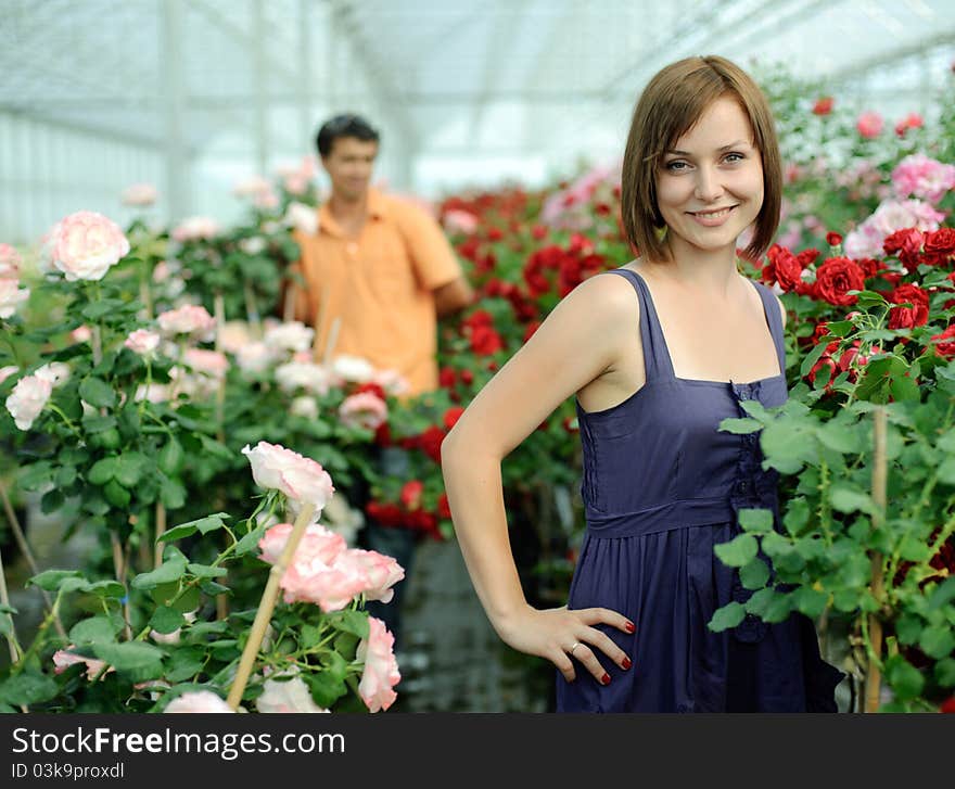 An image of a woman and a man in a greenhouse