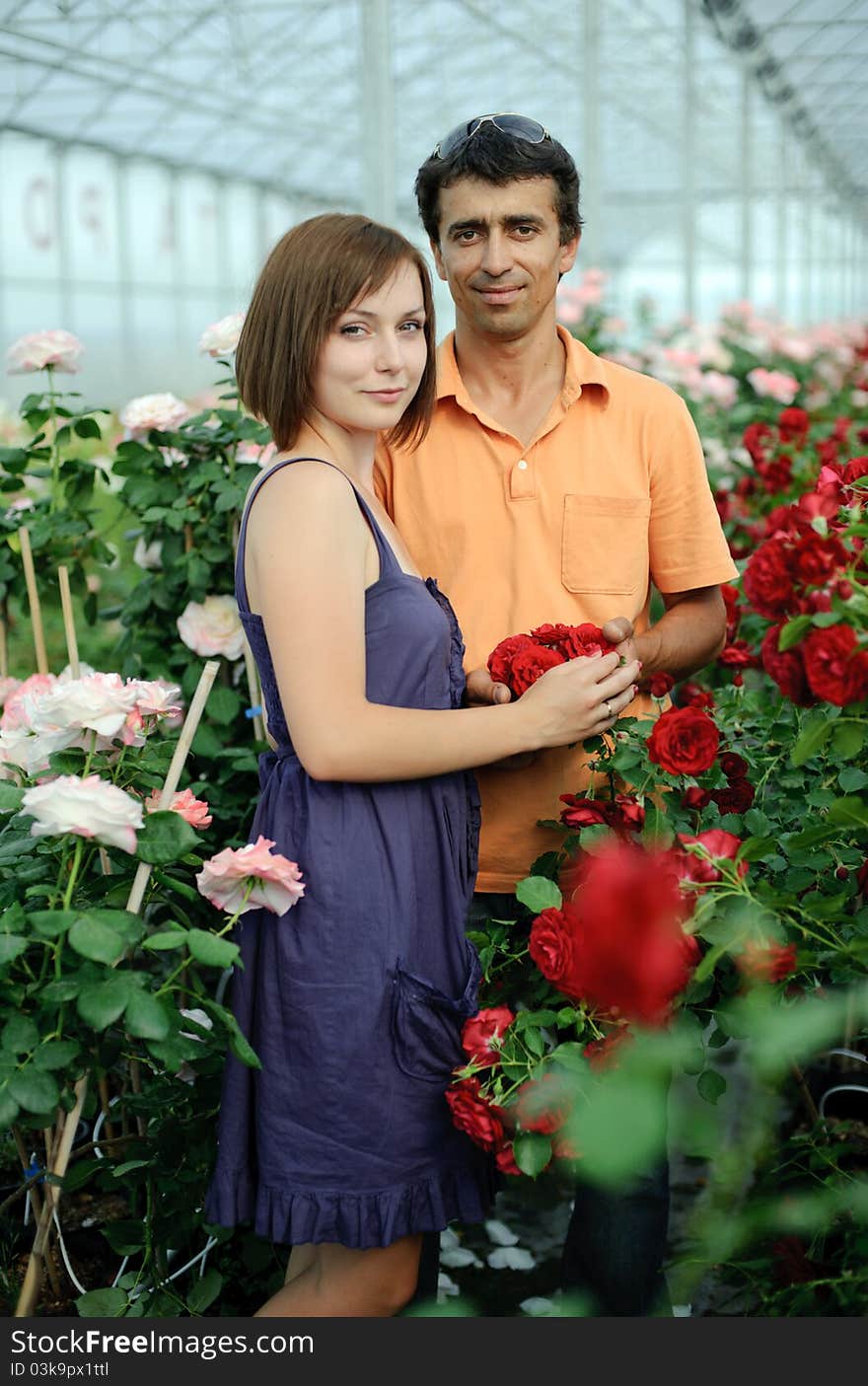 An image of a woman and a man in a greenhouse