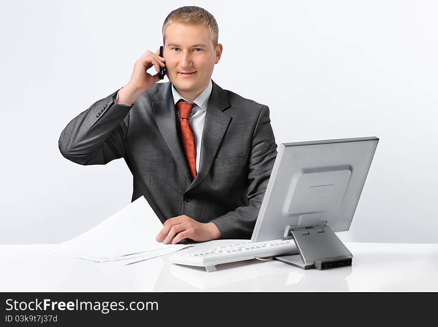 Young successful business man with a telephone and computer