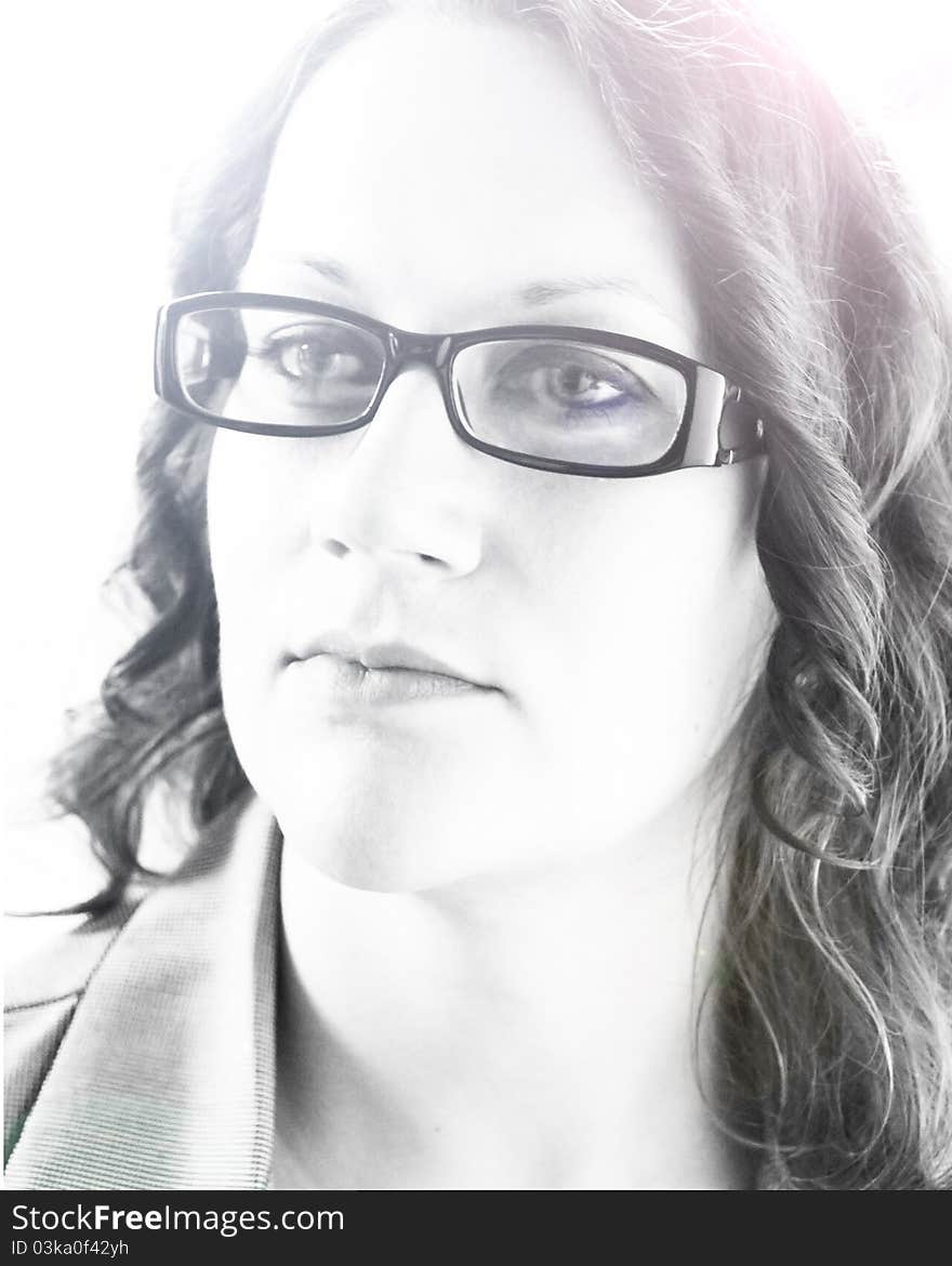 Black and white photo of a curly-haired woman in glasses. Black and white photo of a curly-haired woman in glasses.