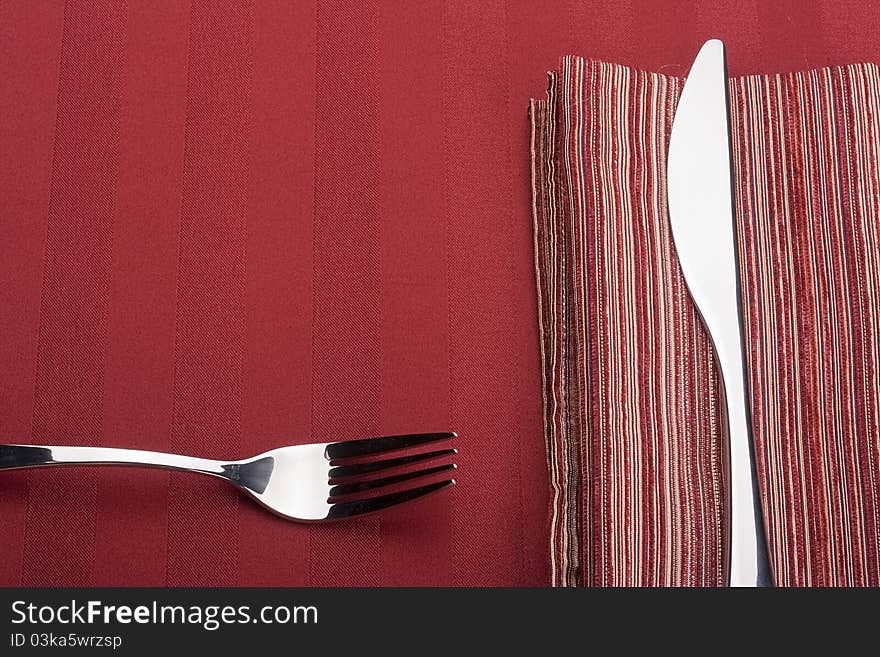 Knife and fork on a napkin as a dining room serving.