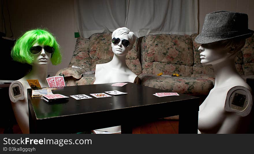 Three mannequins playing poker in the house. Three mannequins playing poker in the house.