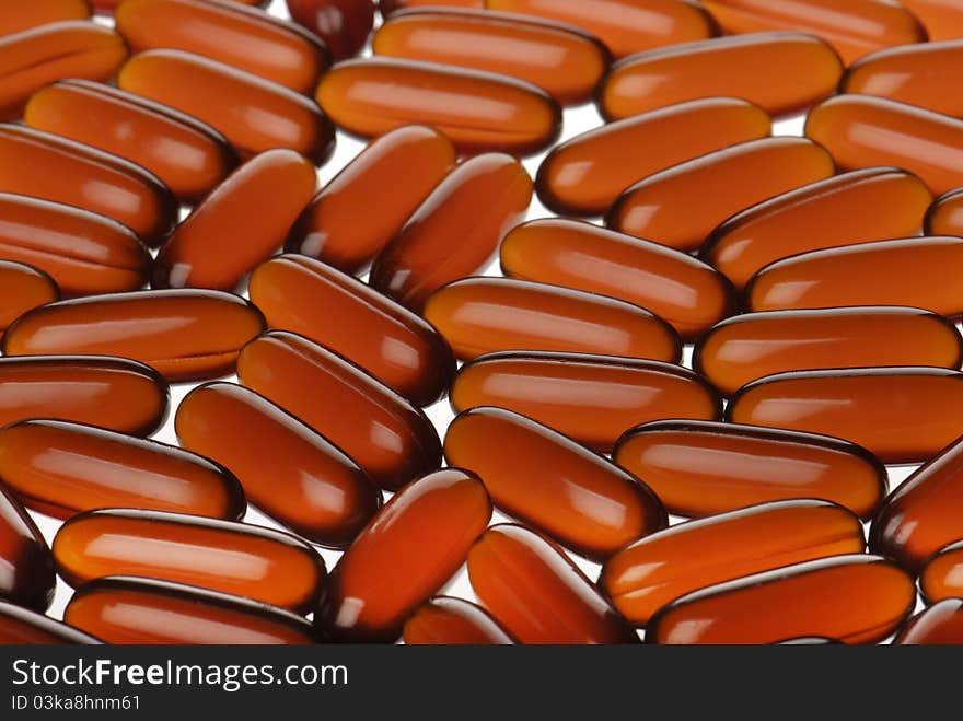 Closeup bright orange capsules background. Closeup bright orange capsules background