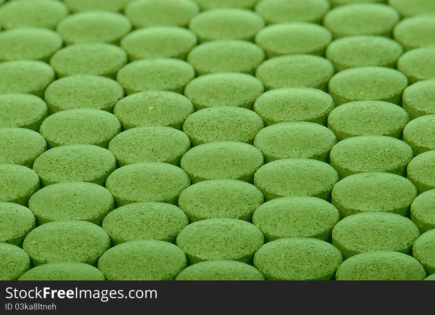 Closeup background of green pills