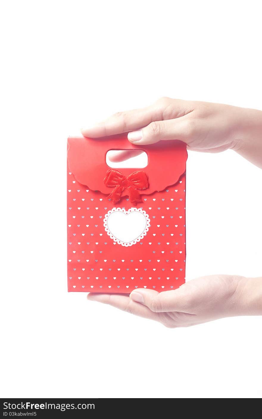 Hand holding red gift bag, isolated on the white background