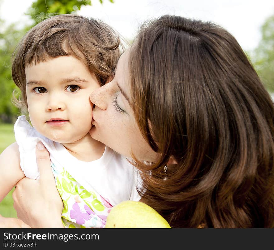 The portrait of the baby and mother on cover in the park. The portrait of the baby and mother on cover in the park