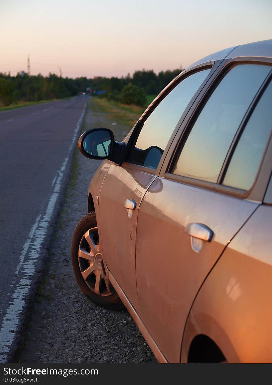 The car is on the side of the road summer. The car is on the side of the road summer