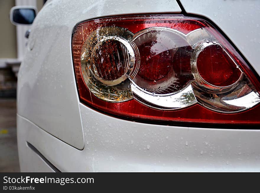 Closeup of tail light of a whtie car