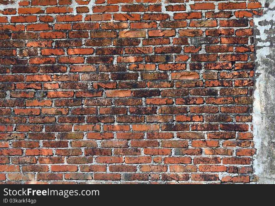 An old brick wall which looks quite aged. An old brick wall which looks quite aged