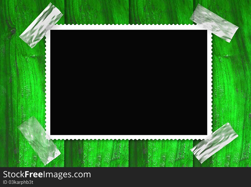 Old picture frame isolated black background, stuck in a wall of green wood. Old picture frame isolated black background, stuck in a wall of green wood