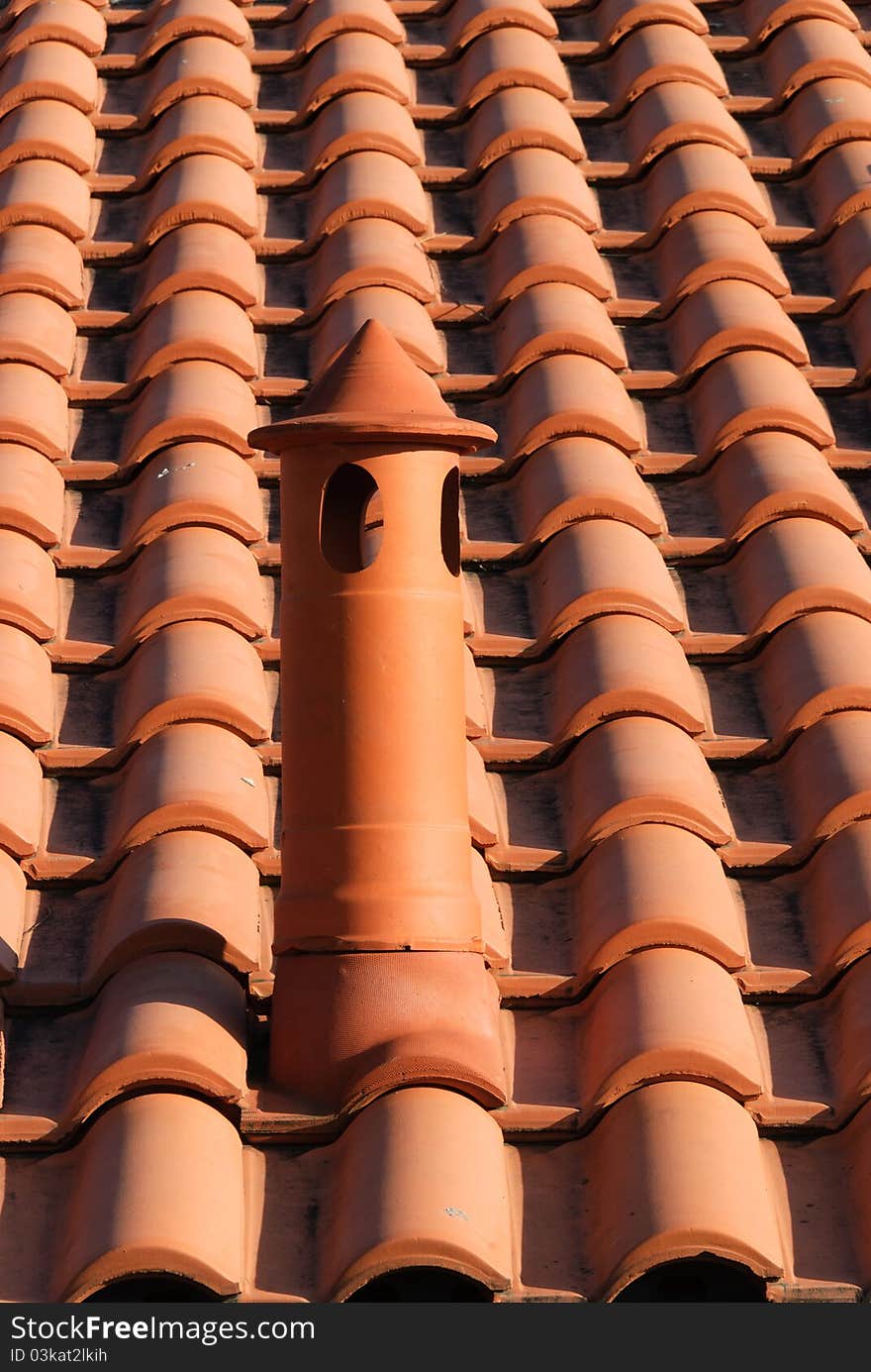 Tile roof with brick chimney