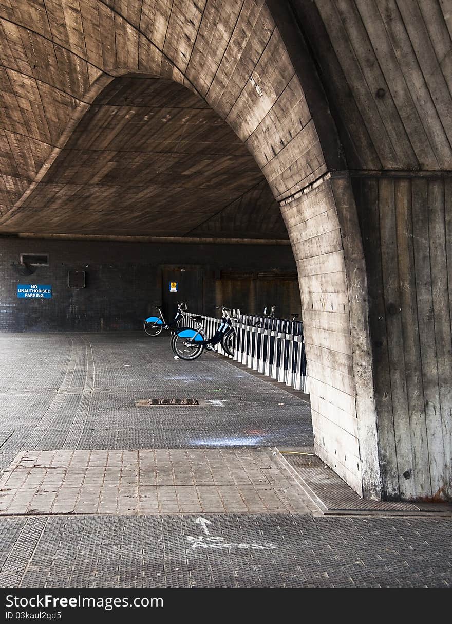 Public rental bicycle station under a bridge in London, UK. Public rental bicycle station under a bridge in London, UK