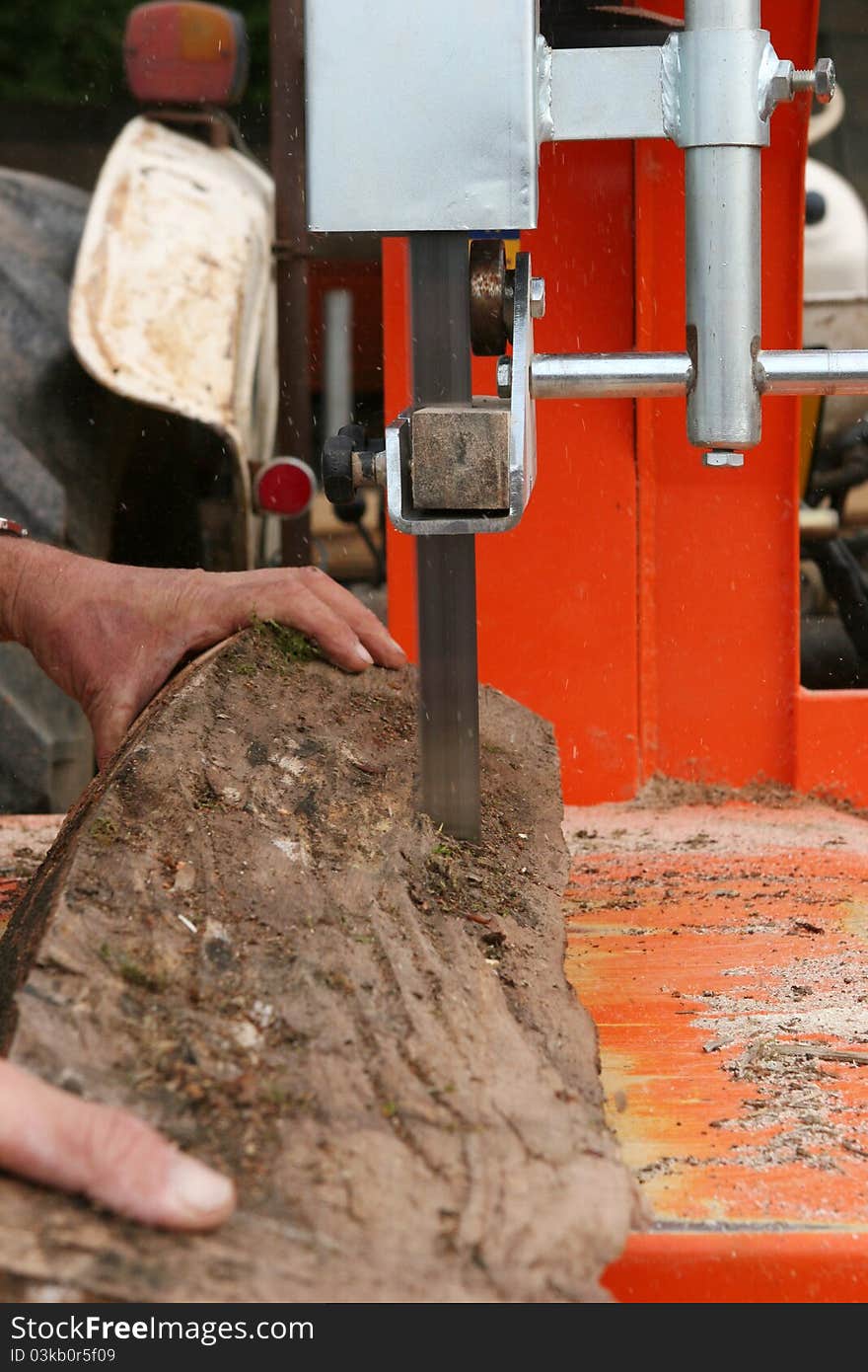 Man cutting a log of wood