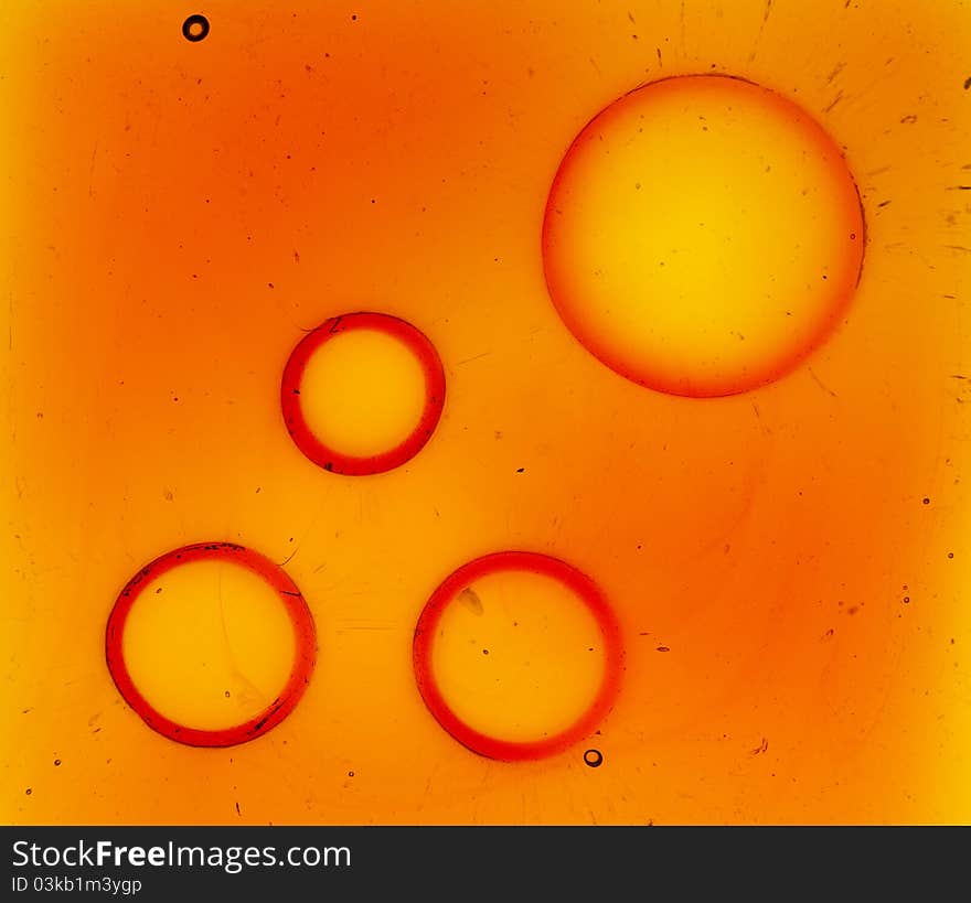 Orange glass background with four big bubbles