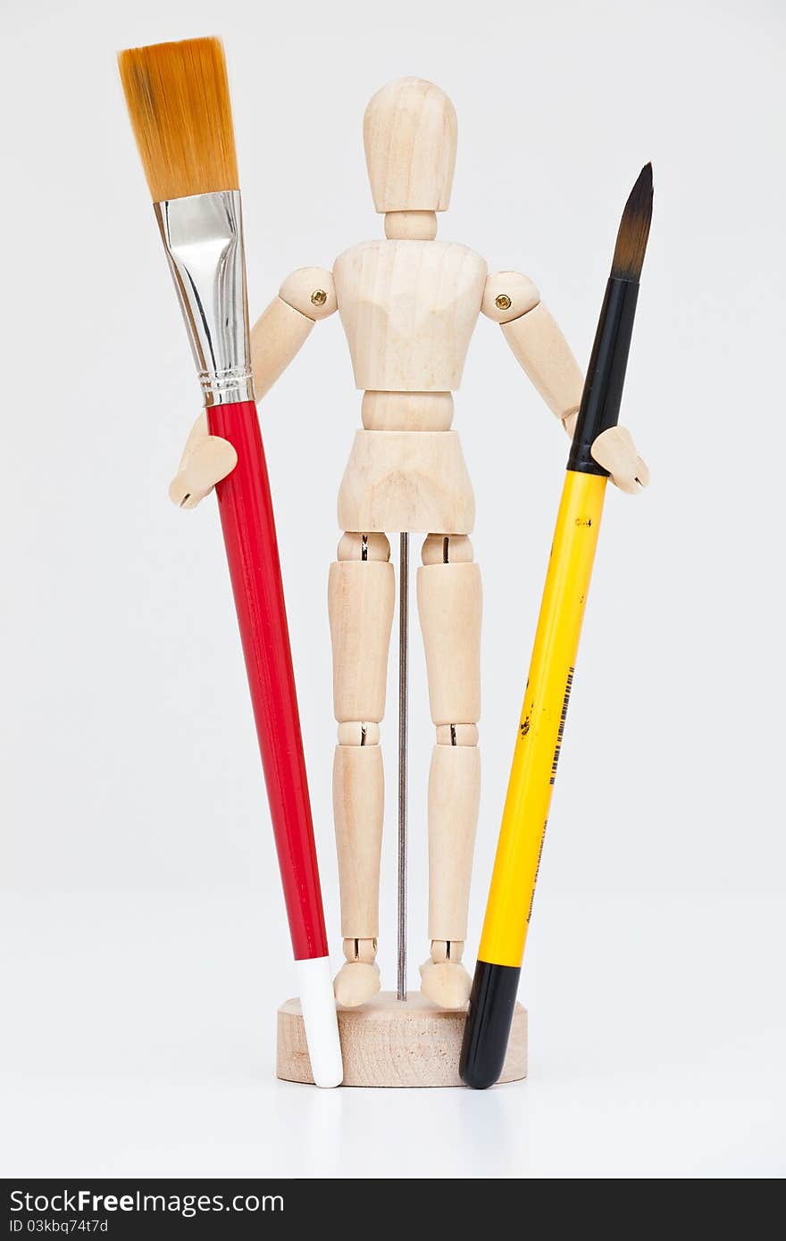 Artist's wooden mannequin with brushes - portrait interior. Artist's wooden mannequin with brushes - portrait interior.