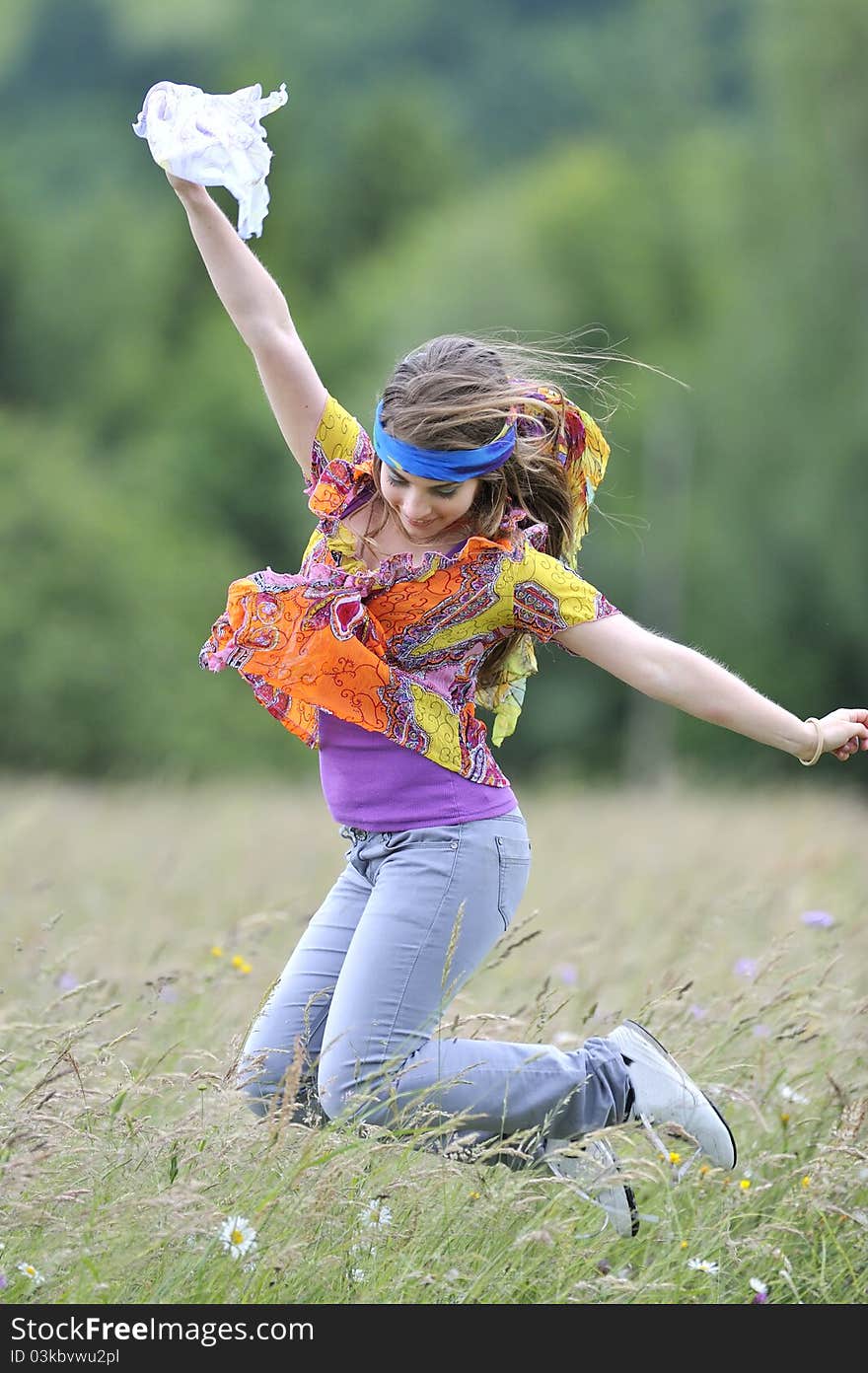 Beautiful woman jump on field in summer time