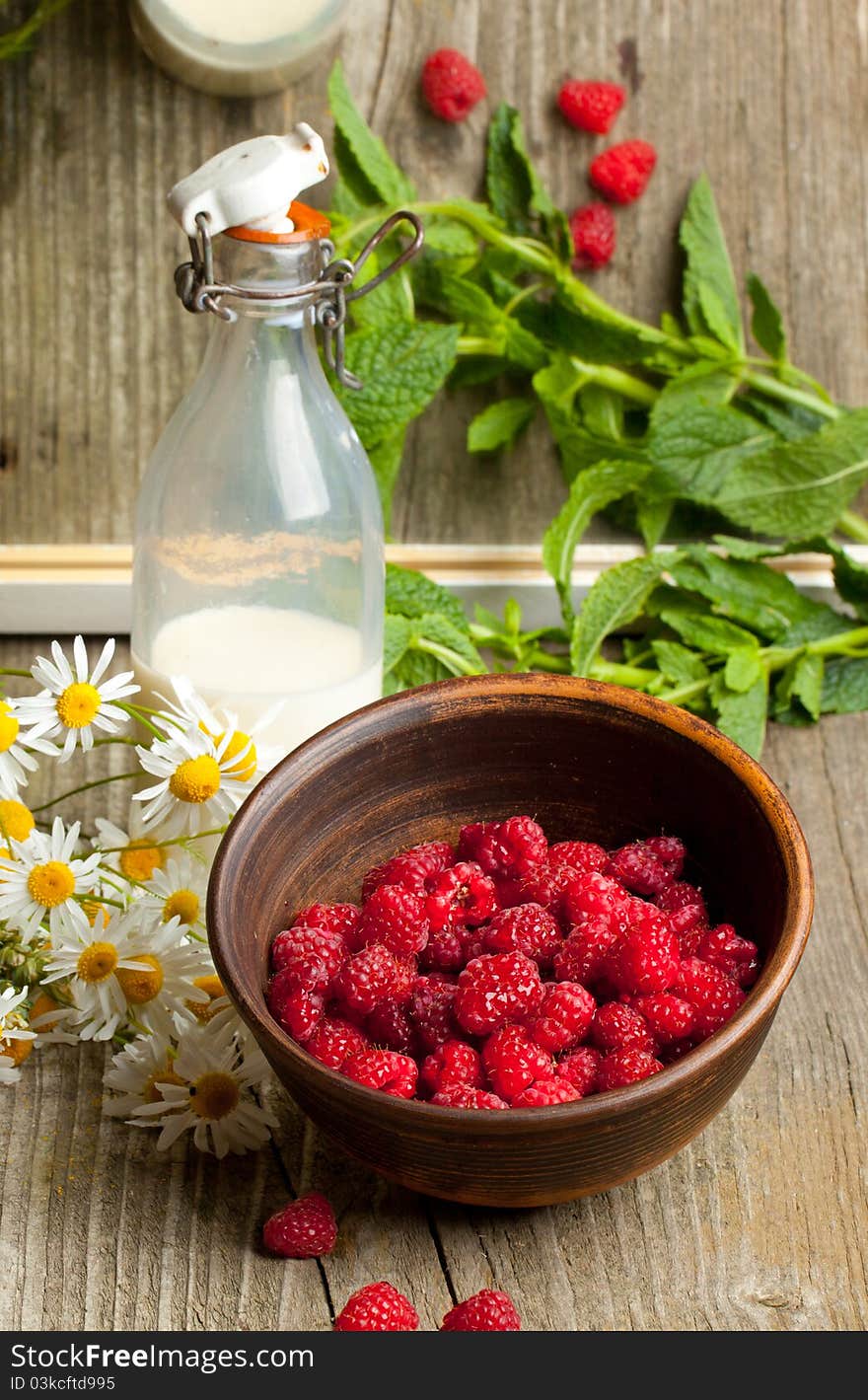 Fresh ripe raspberries and milk