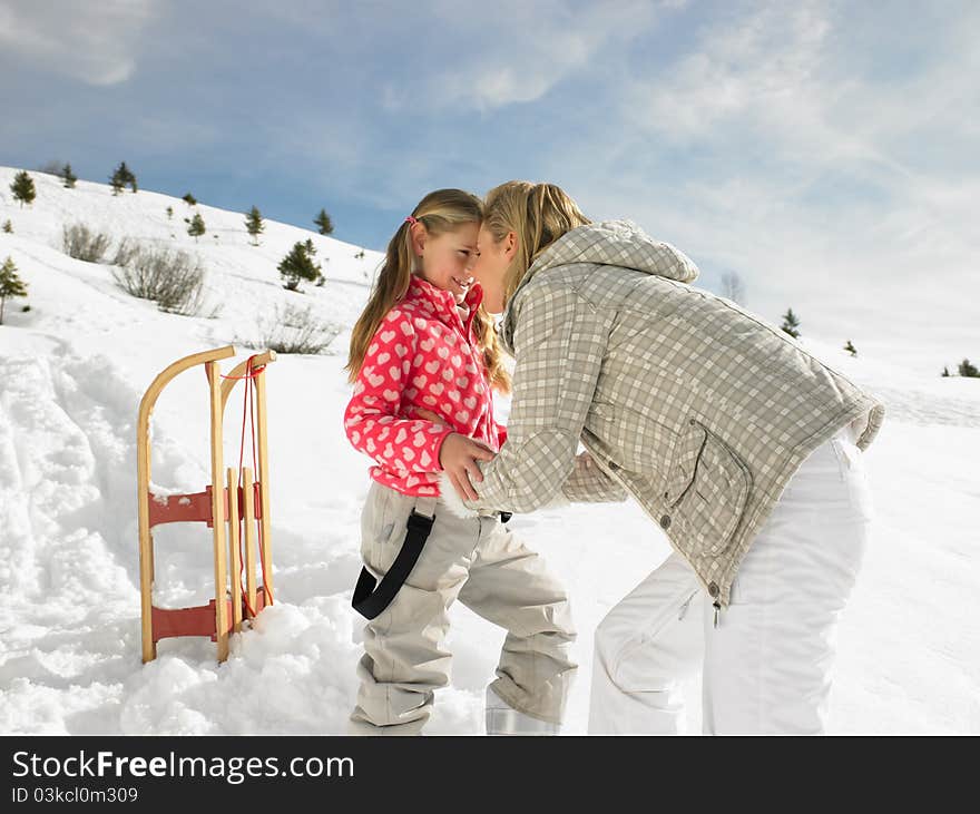 Young Mother And Daughter On Winter Vacation having fun