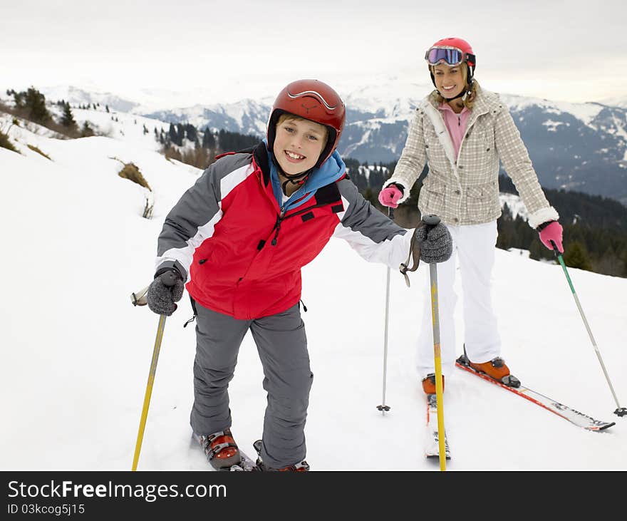 Young Mother And Son On Ski Vacation smiling