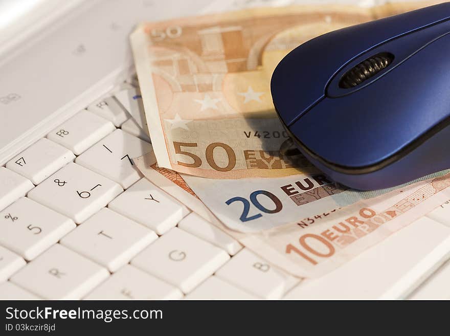 Computer mouse on the keyboard with money to buy online. Computer mouse on the keyboard with money to buy online