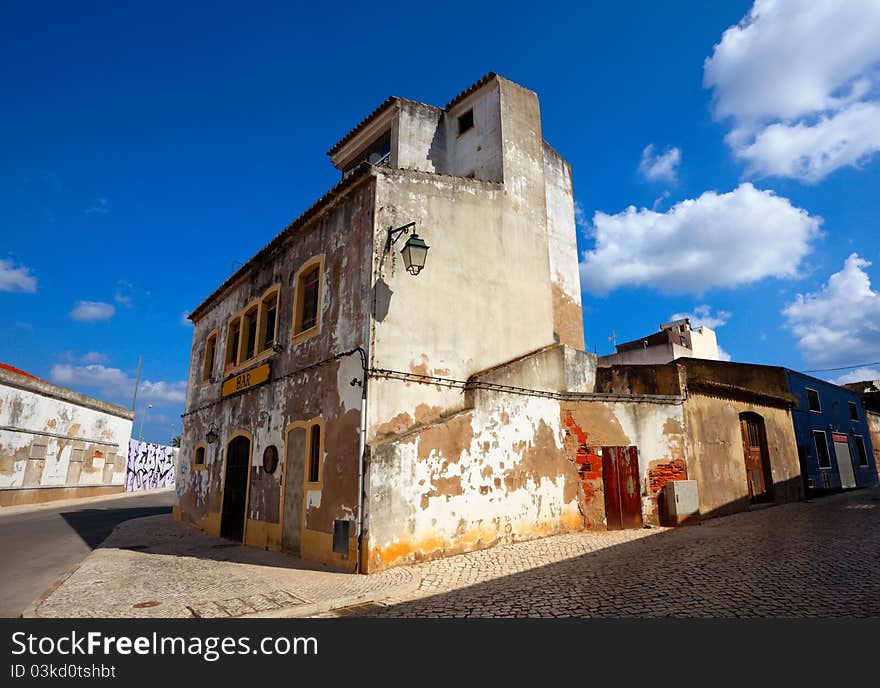 Dilapidated Building with closed bar in old town, Portimao, Portugal. Dilapidated Building with closed bar in old town, Portimao, Portugal