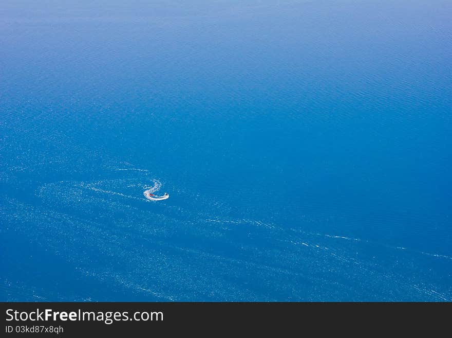 Riding on a boat on a bright blue sea. Riding on a boat on a bright blue sea