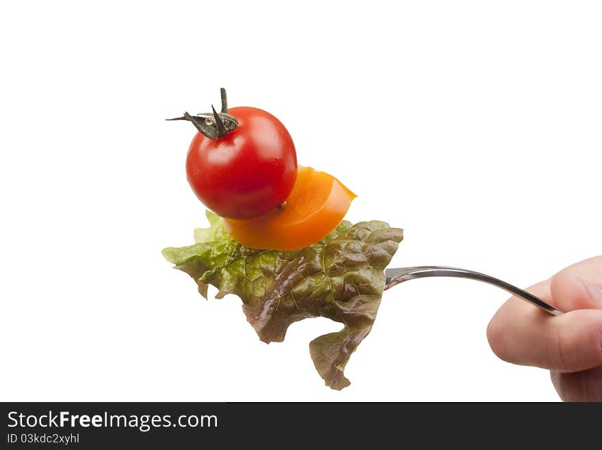 Sandwich of tomato, peppers and lettuce on a fork. Sandwich of tomato, peppers and lettuce on a fork.