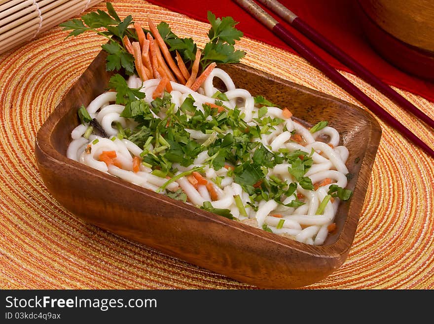 Asian noodle soup in a brown wooden bowl. Asian noodle soup in a brown wooden bowl.