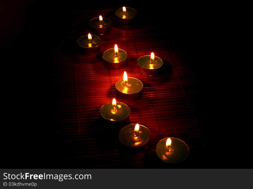 Candles on the bamboo in night.