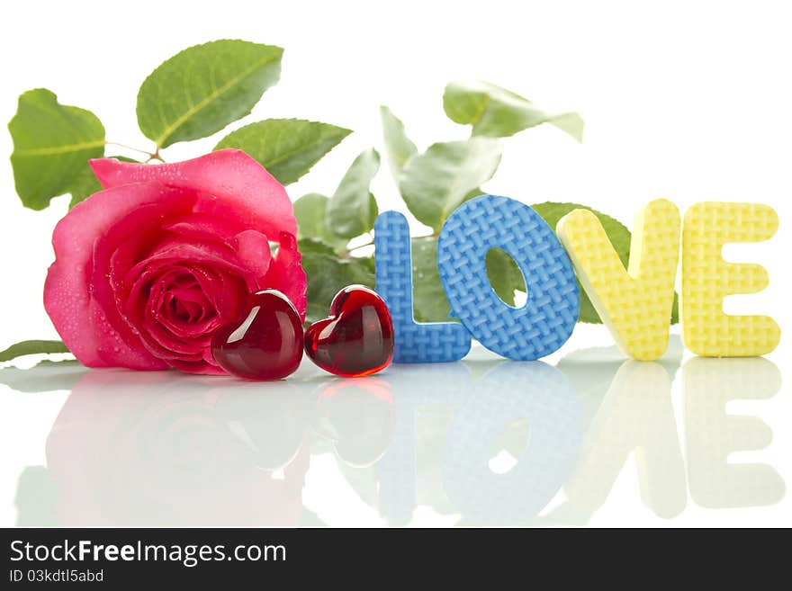 Beautiful red rose, two red hearts and a number of the text of the letters love. Isolated on white background. Beautiful red rose, two red hearts and a number of the text of the letters love. Isolated on white background