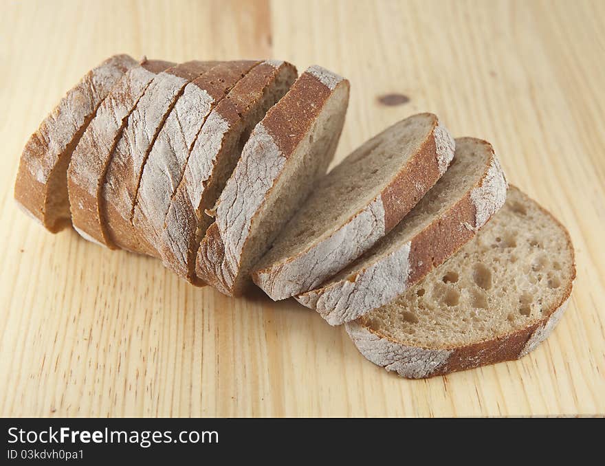 Fresh bread sliced on the wooden board