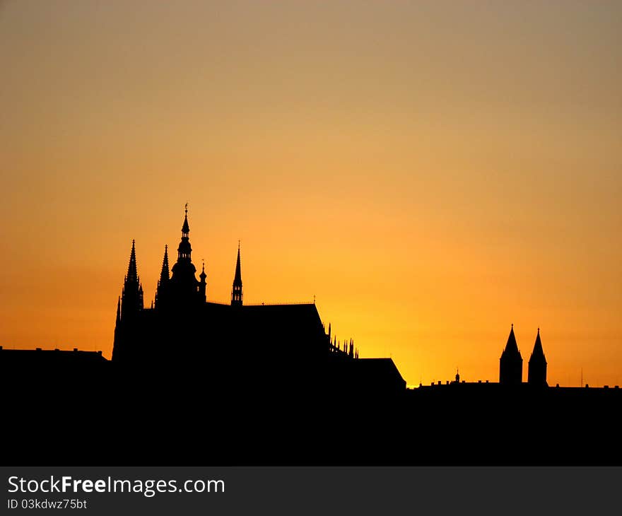 A silhouette of a church in Prague during a sunset with bold red/orange colours. A silhouette of a church in Prague during a sunset with bold red/orange colours.