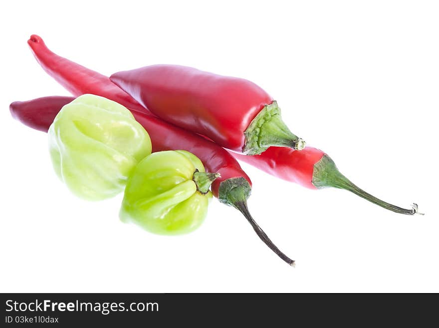 A selection of red & scotch bonnet chillis isolated against a white background. A selection of red & scotch bonnet chillis isolated against a white background