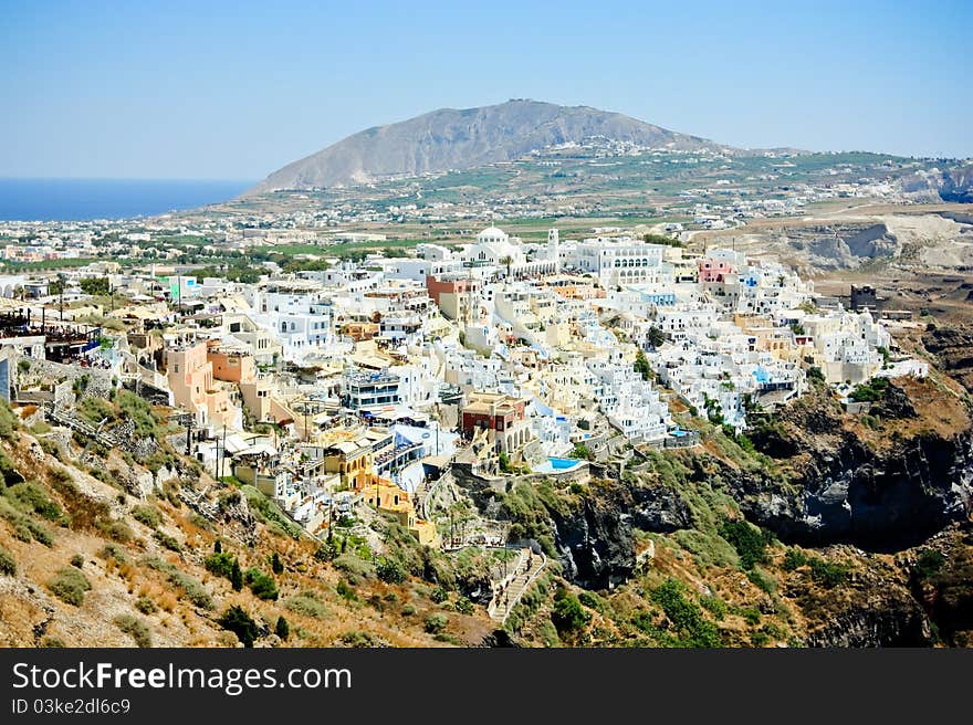 View over the white washed town of fira perched on santorini volcanis cliffs. View over the white washed town of fira perched on santorini volcanis cliffs