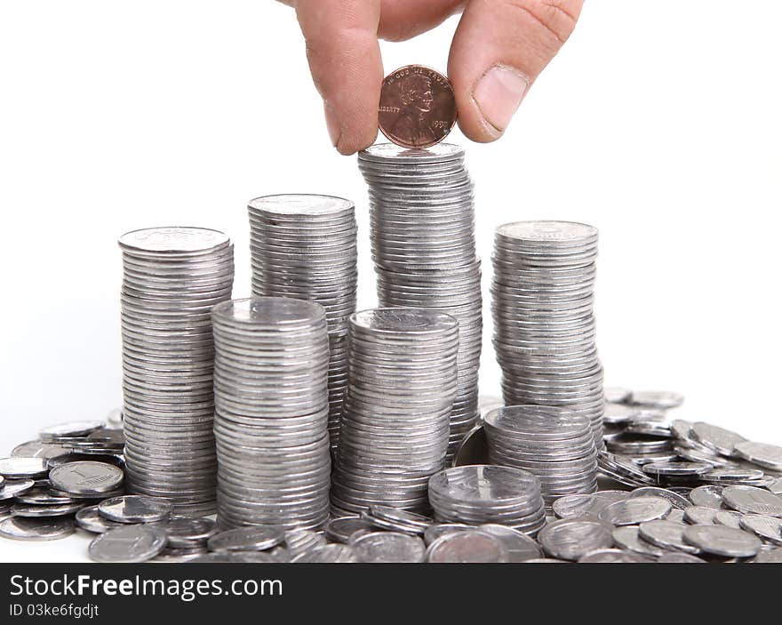 Hand put coin to money staircase. Isolated on white background