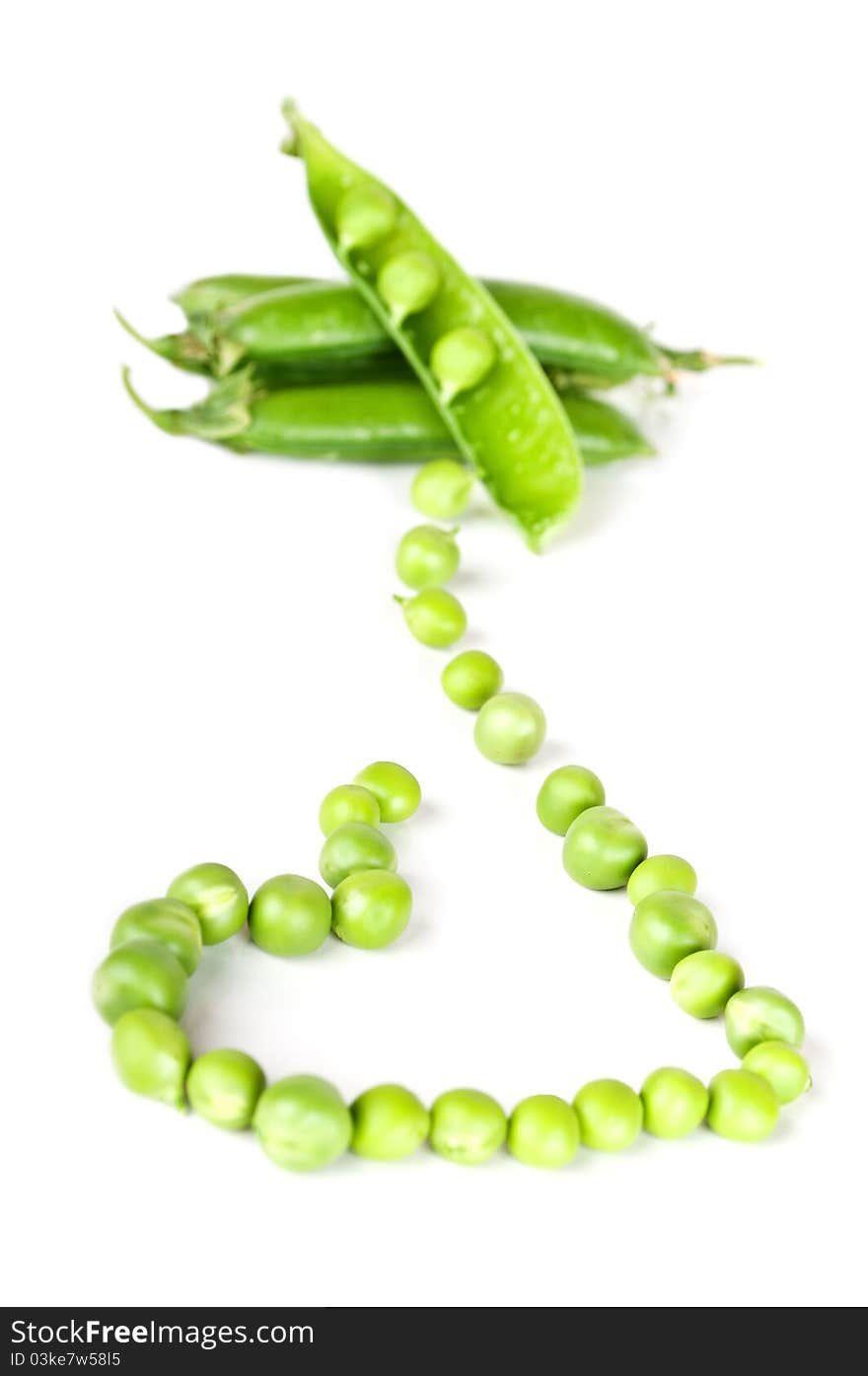 Green peas like a heart isolated on a white background