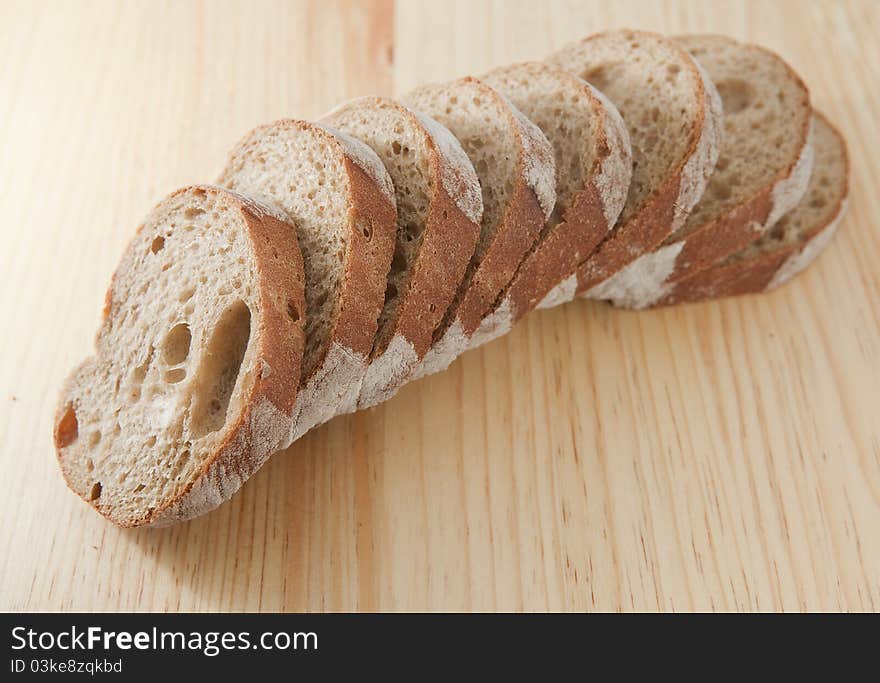 Fresh bread sliced on the wooden board