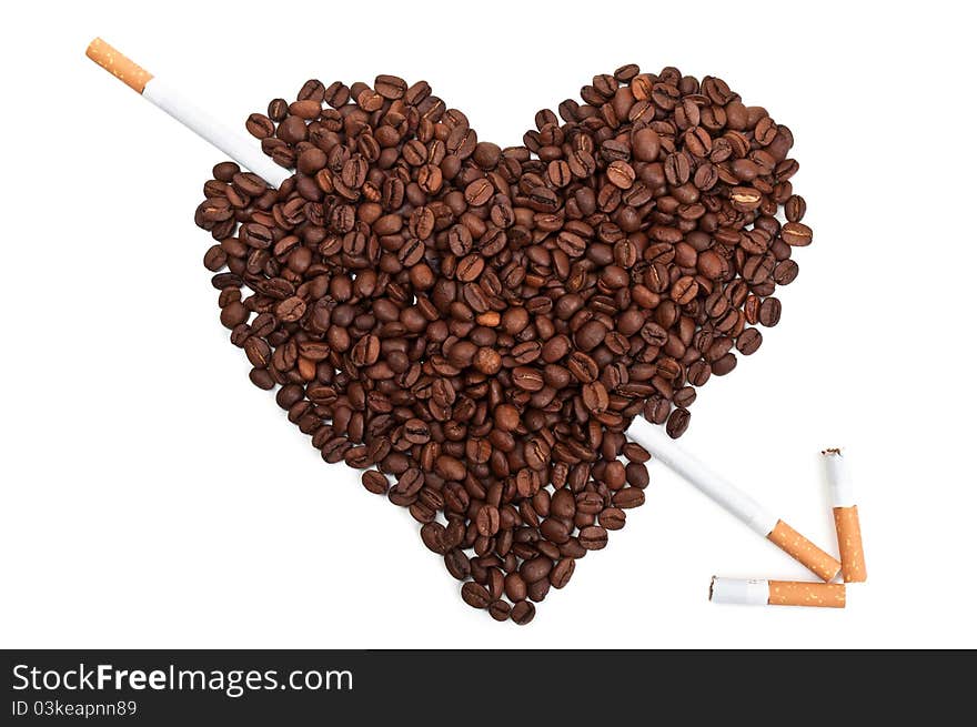 Roasted coffee beans in the shape of the heart with cigarettes isolated on a white background